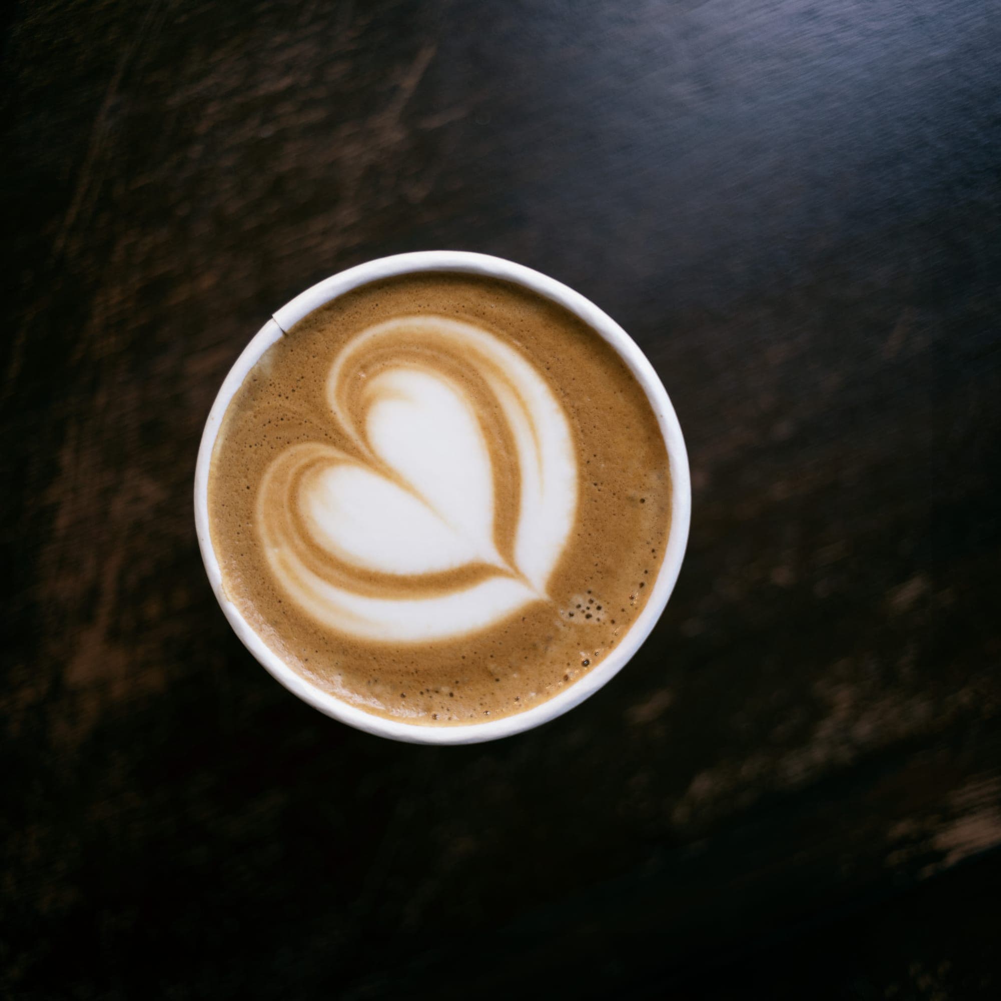 A TOAST coffee with heart latte art